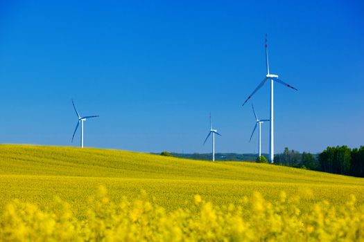 Wind Turbines on spring field. Alternative energy, environment concept