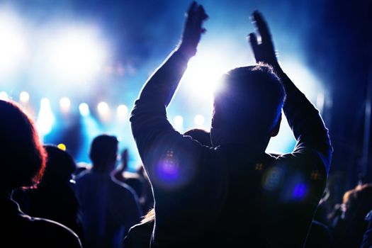 Crowds of people having fun on a music concert