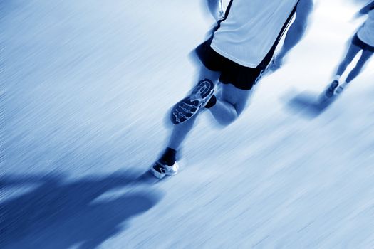 Two runners moving fast. Workout, sport, exercise. Motion blur