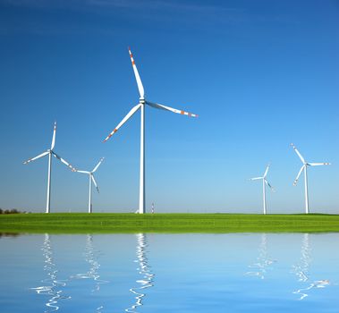 Wind Turbines on green field. Alternative energy, environment concept