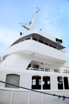 White tourist, luxury ship close up on blue sky