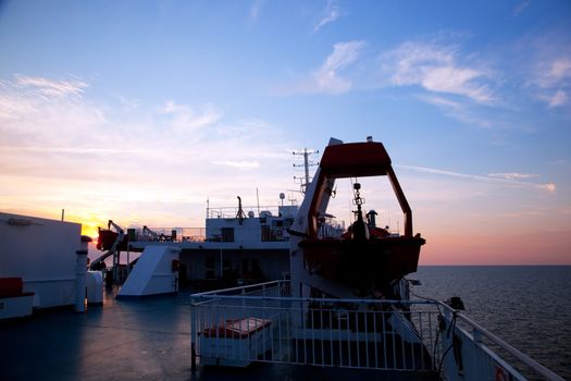 Ship deck, board view. Ocean, sea at sunset