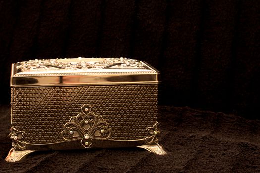 A silver chest on a black fur