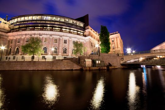 Parliament building in Stockholm, Sweden at night with water reflection