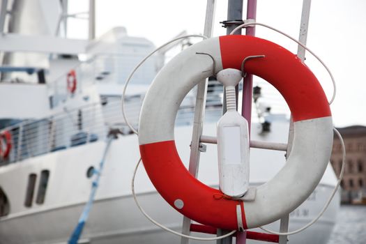 Life belt and a tourist, passenger ship in the background