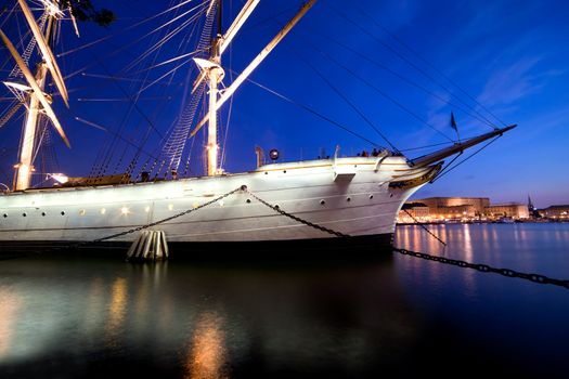 Ship at night in Stockholm, Sweden. City reflections in water