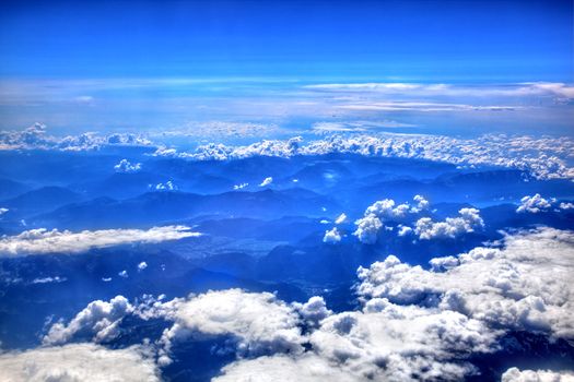 High in the blue sky, puffy white clouds