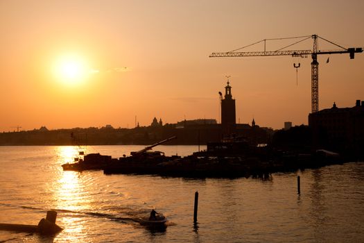 Industrial harbor, port at sunset and a crane
