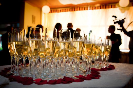 Champagne glasses at the party. People celebrate in the background