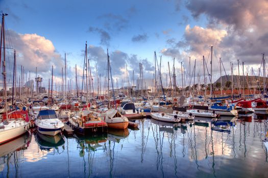 Boats in the harbor of Barcelona, Spain at sunset