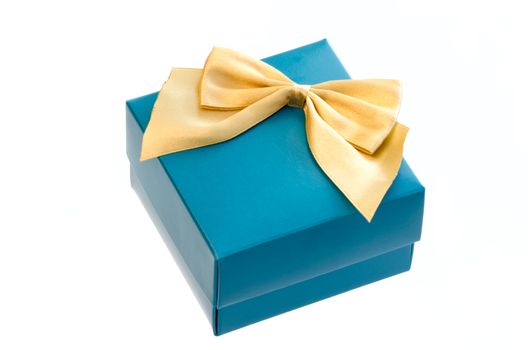 Gift box with a gold ribbon bow isolated on white background.