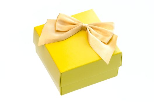 Gift box with a gold ribbon bow isolated on white background.