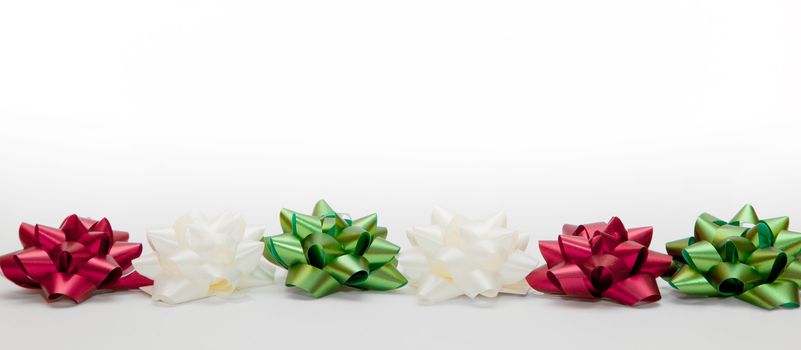 Christmas decoration. Colorful ribbon and little stars on white