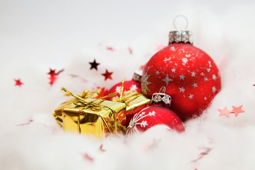 Christmas balls frozen in soft cotton wool resembling snow