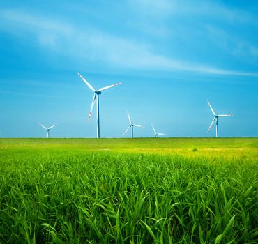 Wind turbines on green field. Alternative source of energy