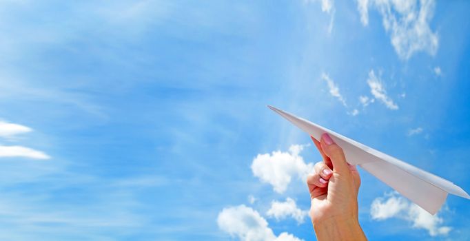 Throwing a paper plane in the sky. Freedom, success, vacation, business concepts