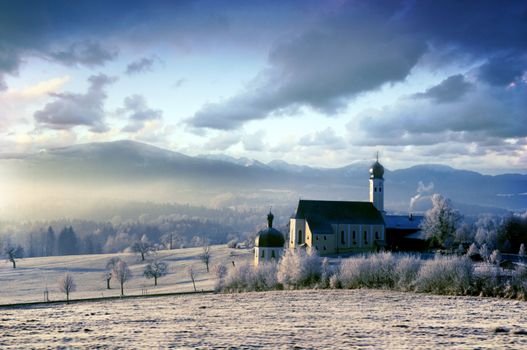 Beautiful frosty morning in the alpine scenery with pictursque church