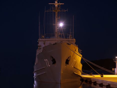 military ship anchored in winter night