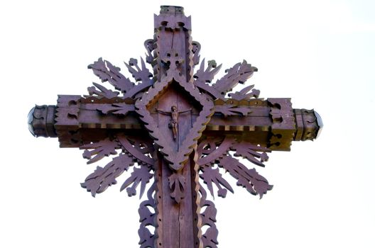 Carved wooden cross with crucified Jesus isolated white background