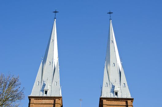 Church towers twins on background of blue sky. Religion.