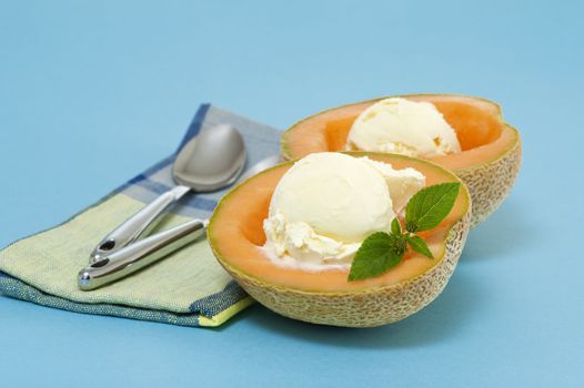 Cantaloupe halves filled with vanilla ice cream.
