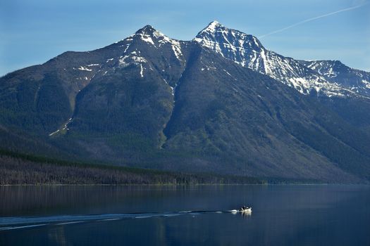 Lake McDonald Going Fishing Outboard in front of Snow Mountain Glacier National Park Montana