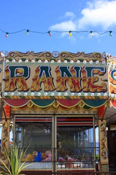 Detail of a seaside attraction with colourful hand painted signage. Located on the seafront at Swanage in Devon.