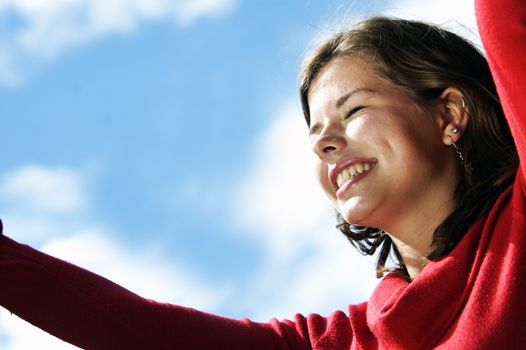 Loving life. Happy girl looking on puffy clouds