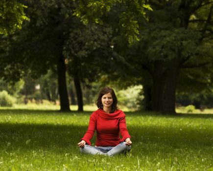 A beautiful young woman doing yoga in the park
