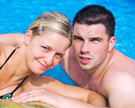 A happy couple enjoying themselves in a pool