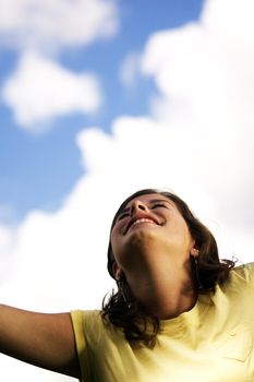 Loving life. Happy girl looking on puffy clouds