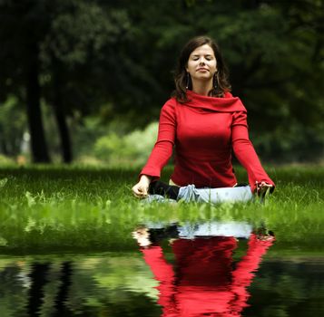 A beautiful young woman doing yoga in the park