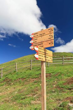 signs for trekking in Italian Dolomites on a sunny day