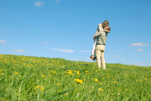 Couple in love having fun on spring meadow