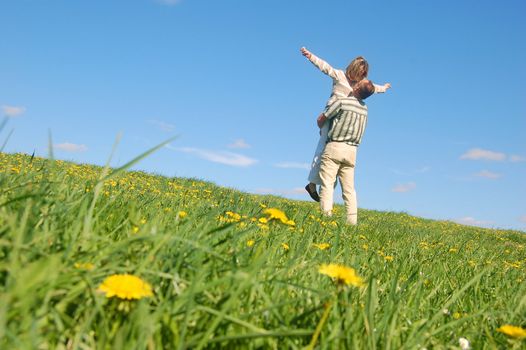 Couple in love having fun on spring meadow