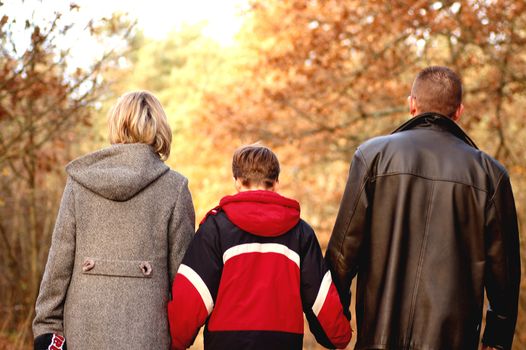 Family walk in autumn scenery