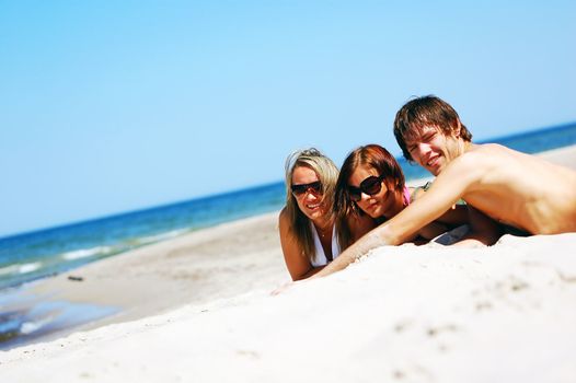 Young attractive friends enjoying together the summer beach