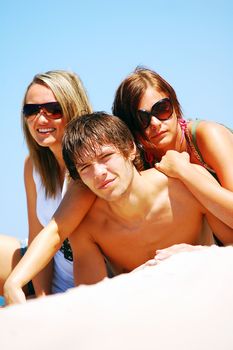 Young attractive friends enjoying together the summer beach