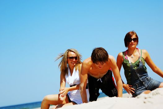 Young attractive friends enjoying together the summer beach