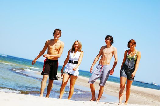 Young attractive friends enjoying together the summer beach