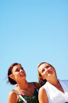 Young attractive girls looking up to the sky