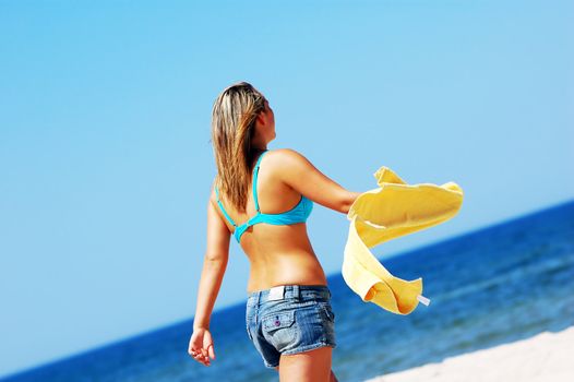 Young attractive woman enjoying summertime on the beach