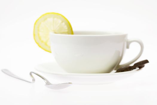 white cup with a lemon isolated on white