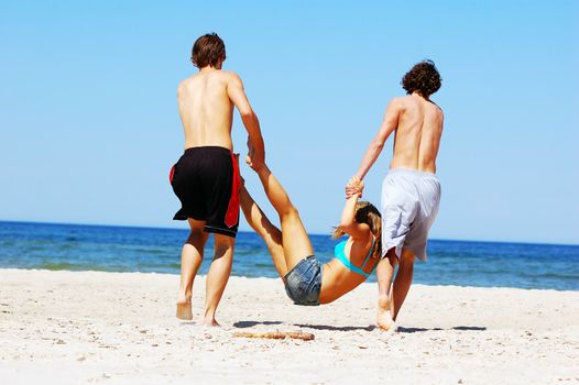 Young attractive friends having fun the summer beach