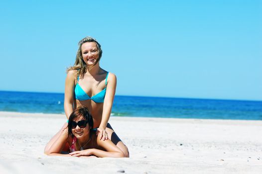 Young attractive girls enjoying together the summer beach