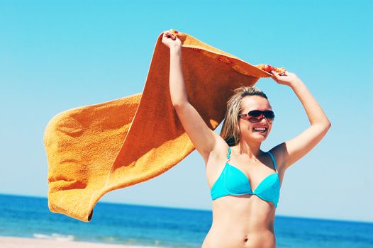 Young attractive woman enjoying summertime on the beach