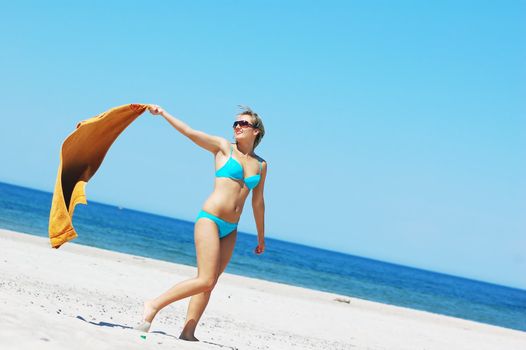 Young attractive woman enjoying summertime on the beach