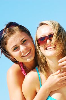 Young attractive women enjoying together the summer beach