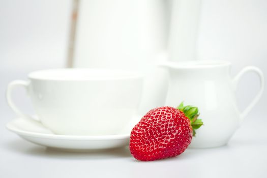 strawberry, white cup and teapot isolated on white