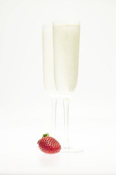 juicy strawberries and champagne glass isolated on white